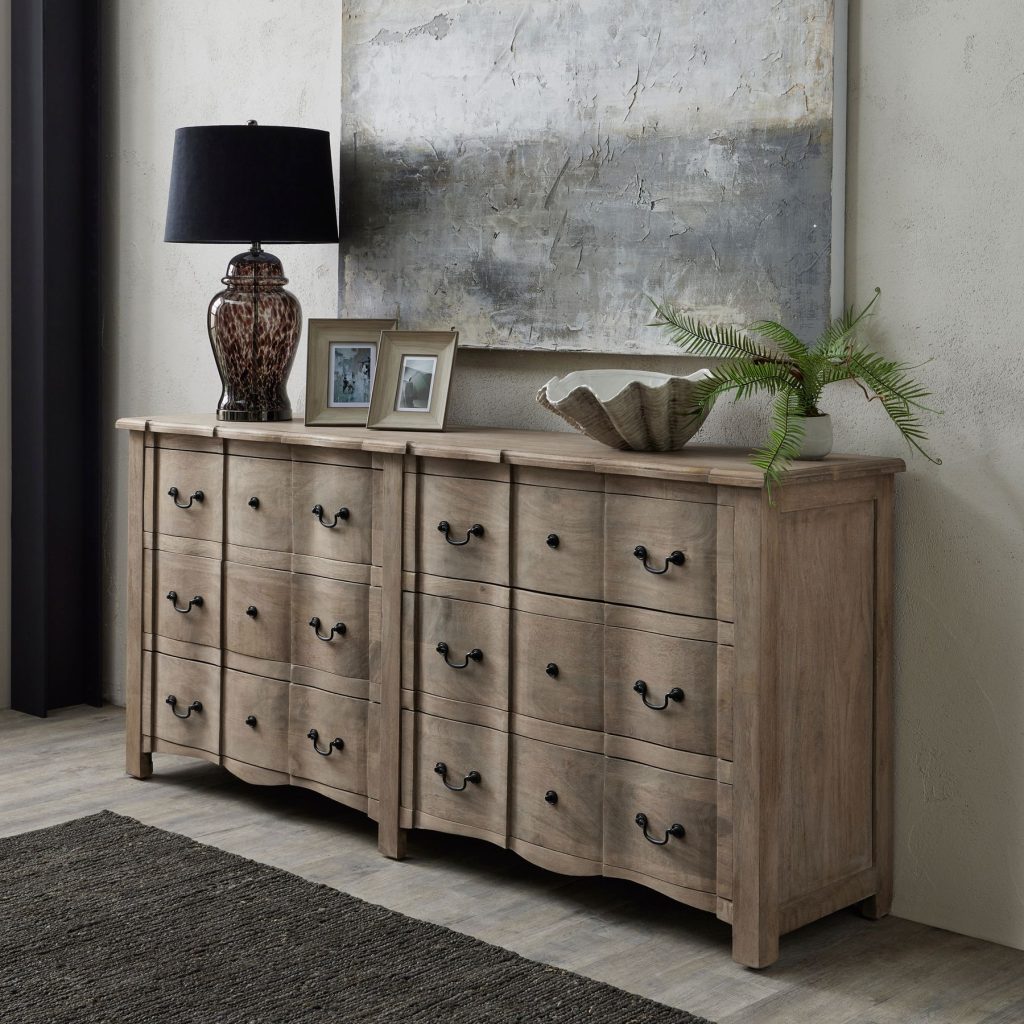 Sideboard styled with lamps, books, and vases